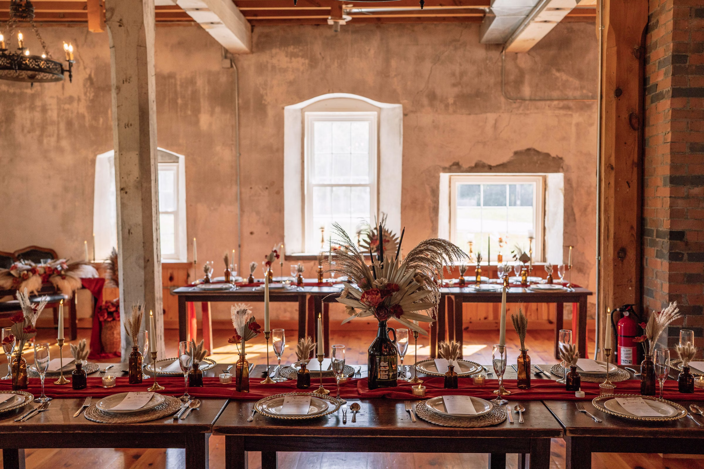 Long banquet reception tables inside the historic stone interior of The Mill on Rush Creek in Rushford, MN