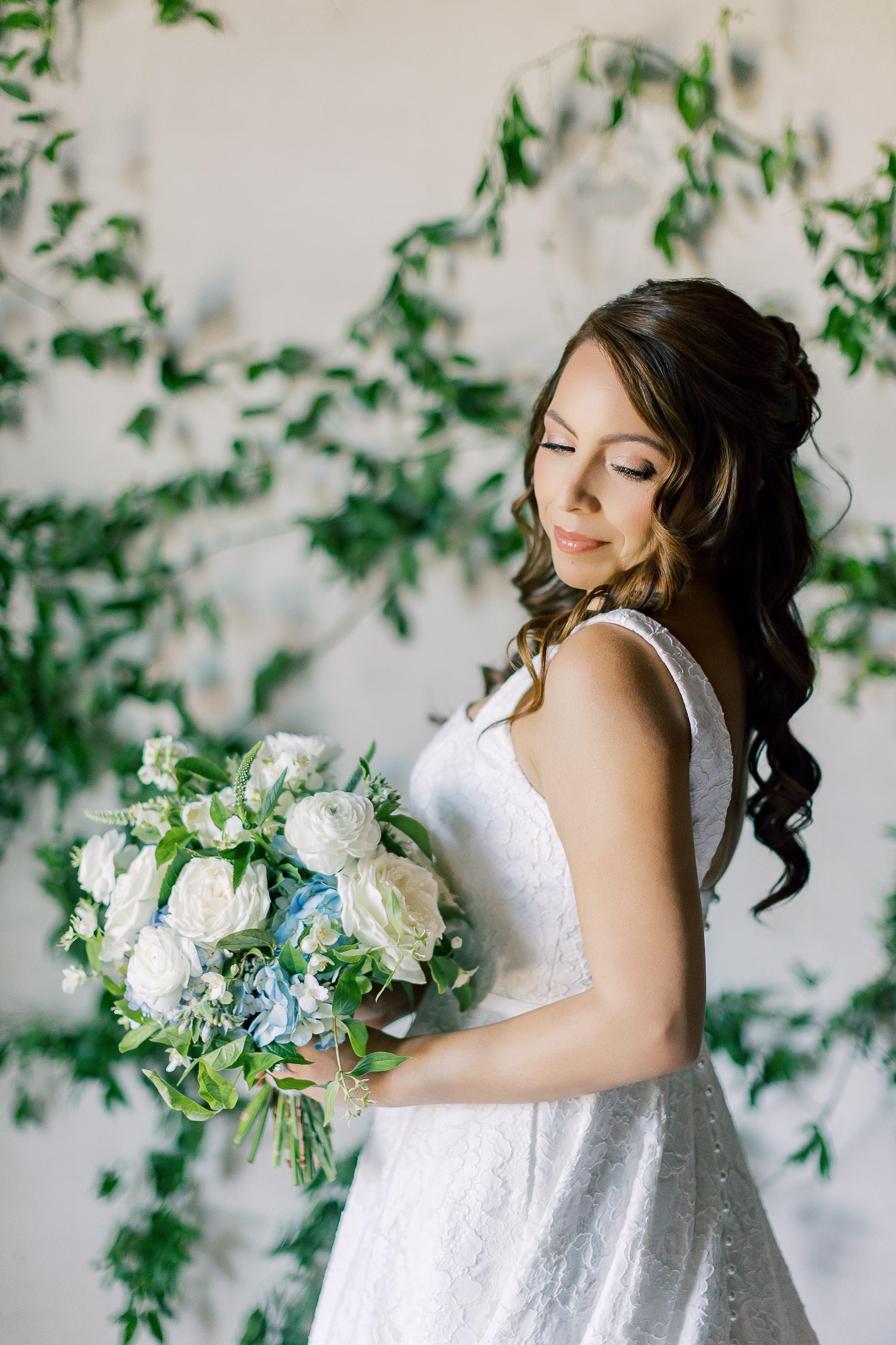Organic bridal bouquet with white roses, ranunculus, blue hydrangea and greenery