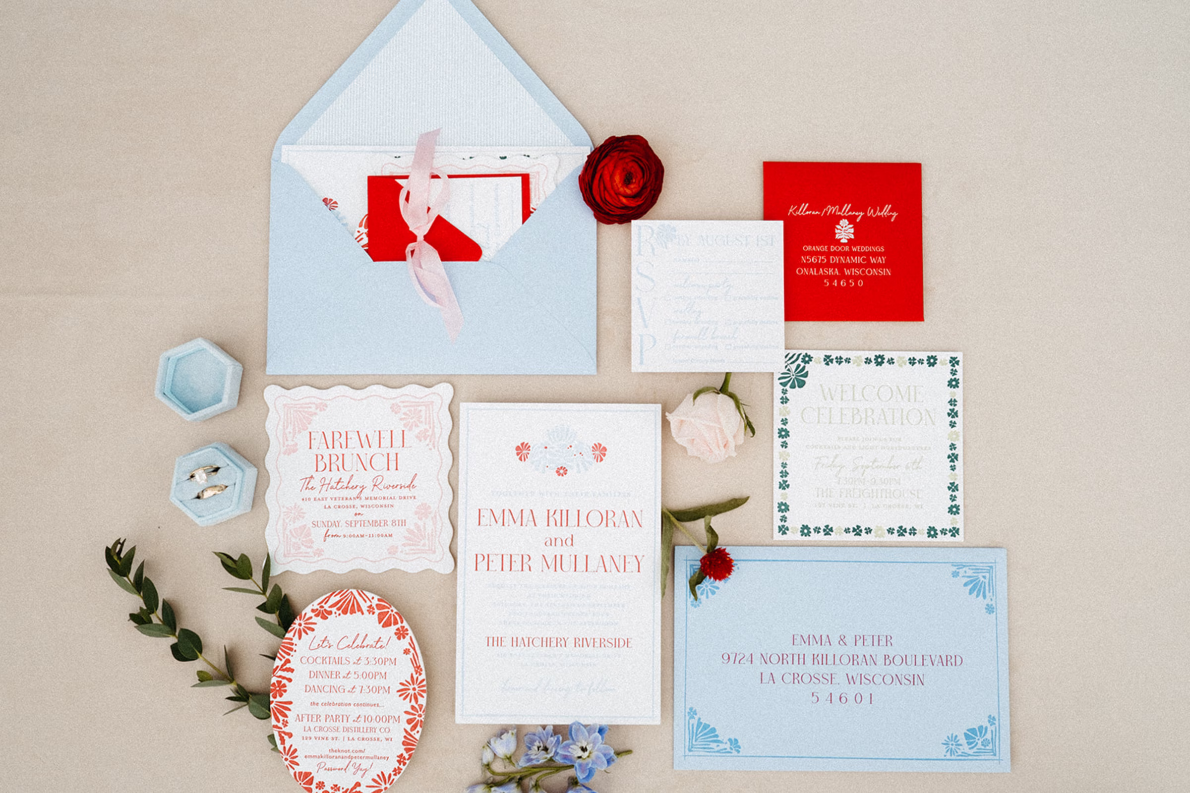 a French inspired stationery suite, with light blue and bold red colors, floral motifs, and a mix of modern and script typefaces