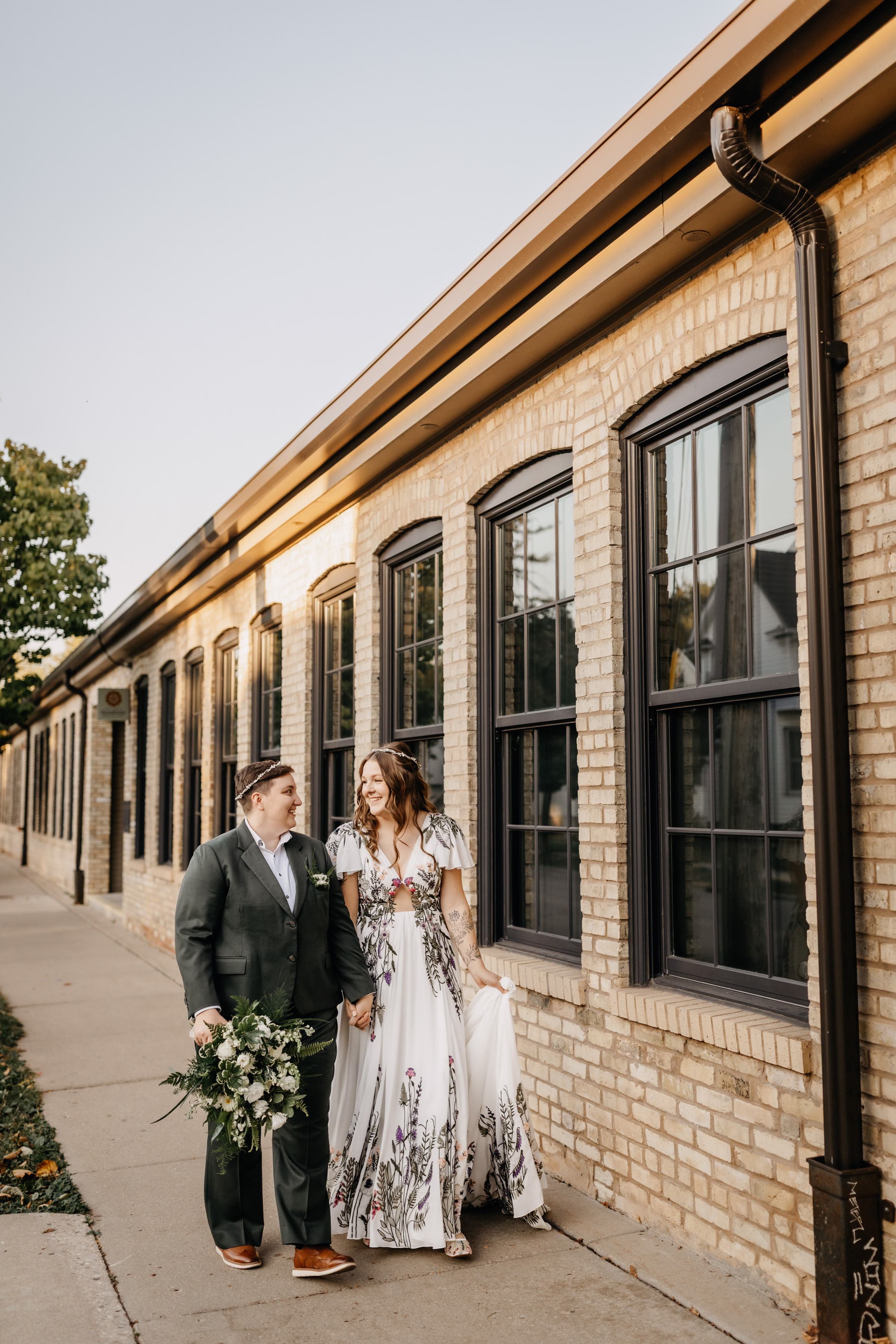 Sam & Janine walk hand in hand alongside Goodman Community Center in Madison, Wisconsin