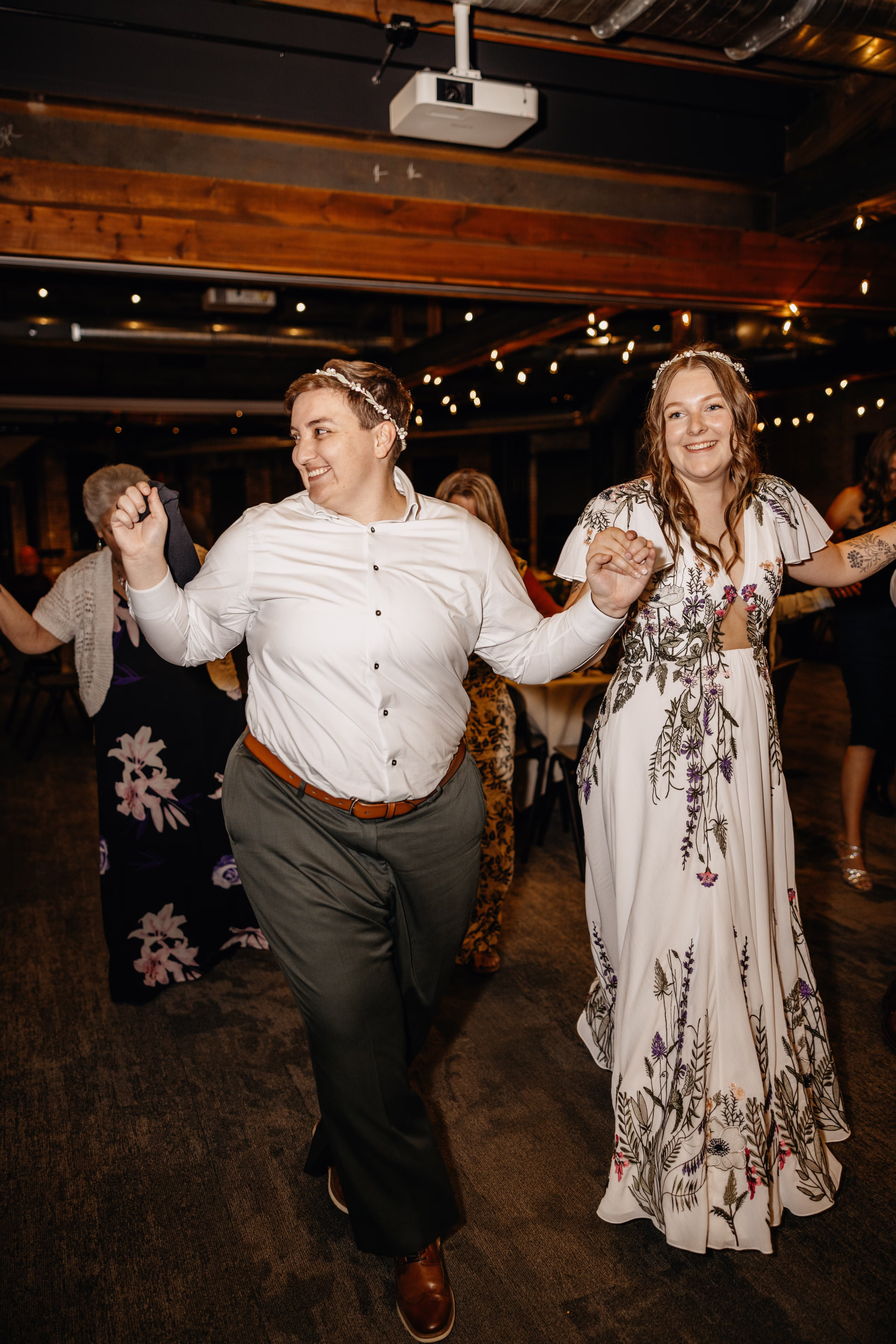 Sam & Janine hold hands on the dance floor