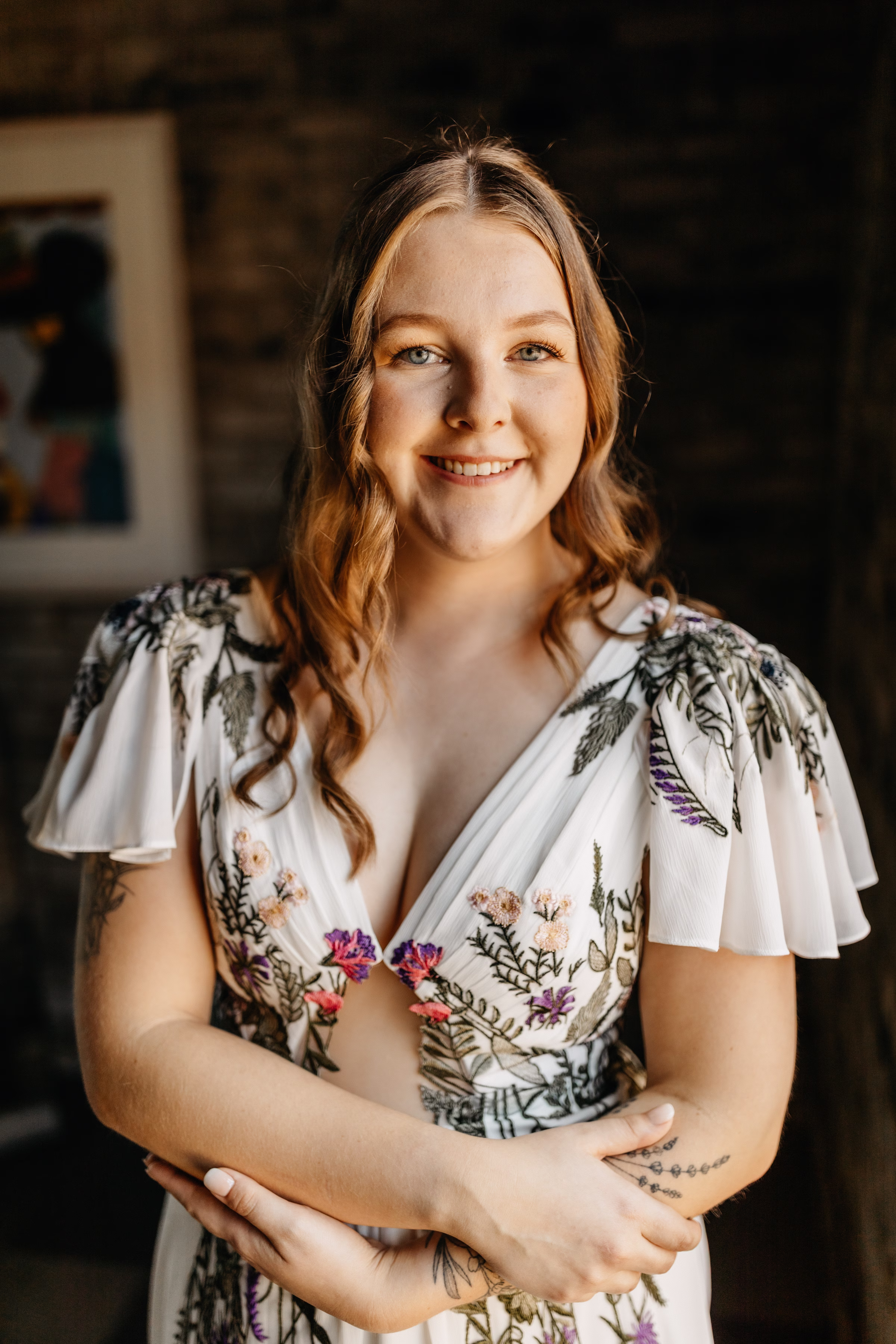a bride smiles at the camera as she prepares for her wedding day
