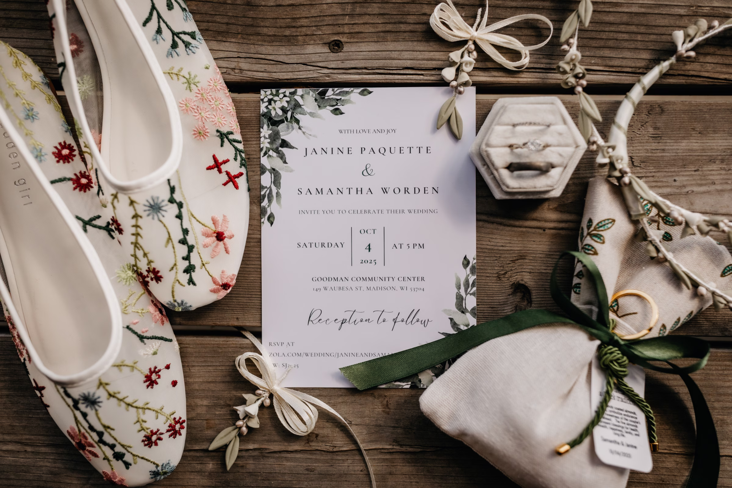 a photo of the couple's invitation beside colorful embroidered bridal flats, taupe and green earrings, and accessories