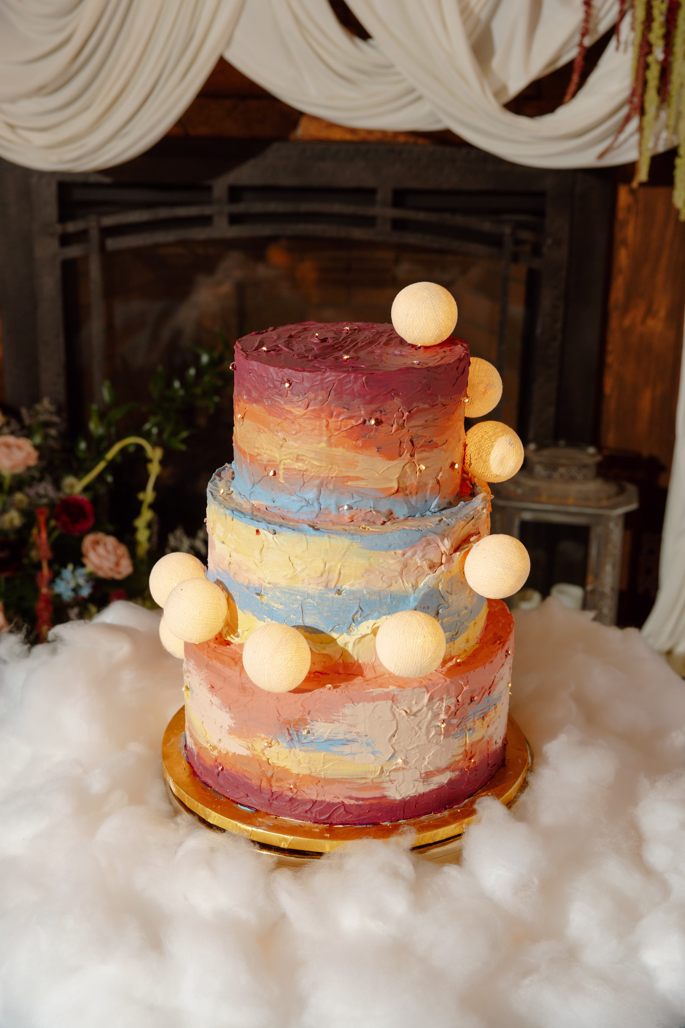 a celestial summer sunset wedding cake by Cowboy David's Bakery with painted frosting and playful moons