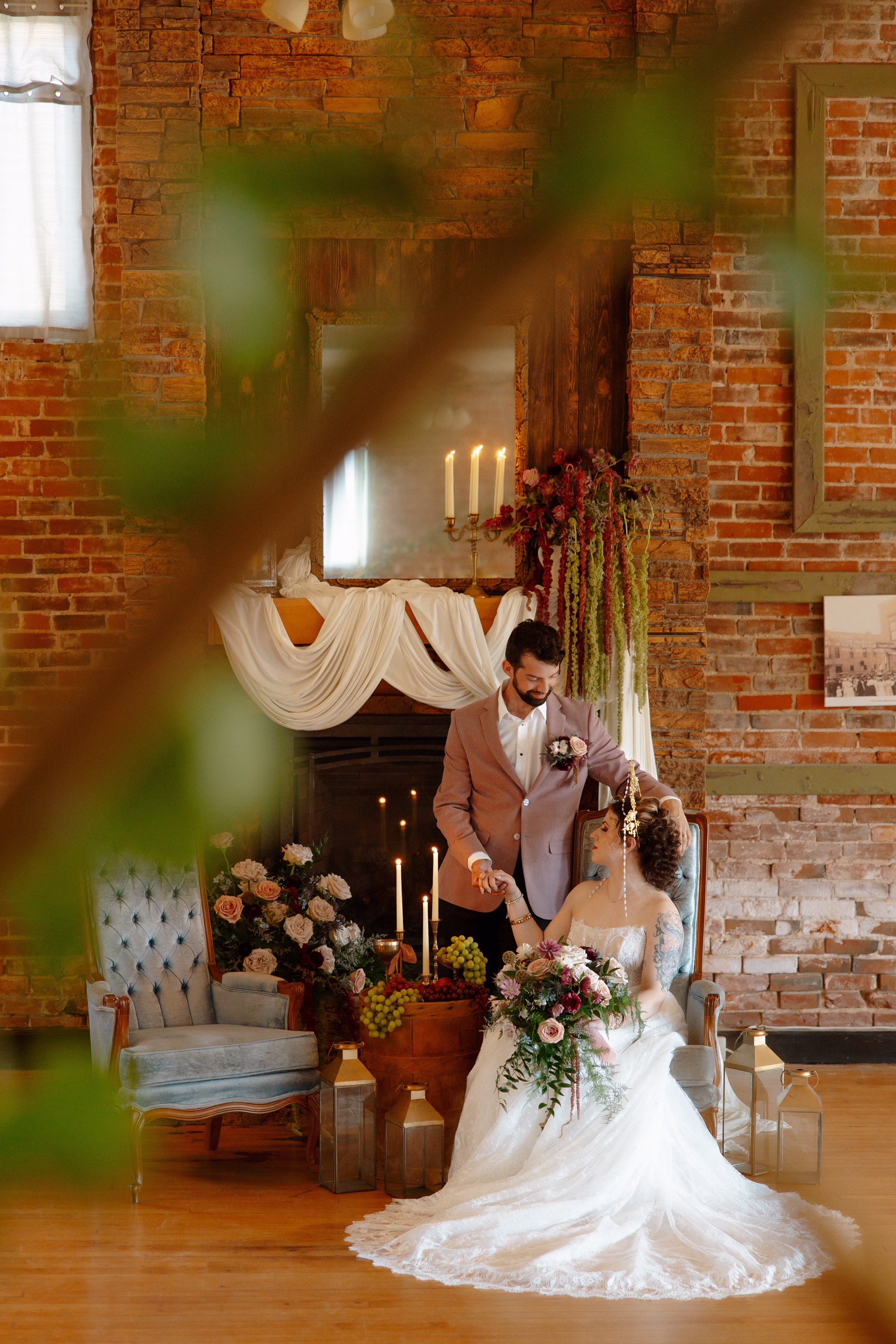 bride and groom models post together in the cozy celestial wedding inspired lounge at B's Place Event Venue