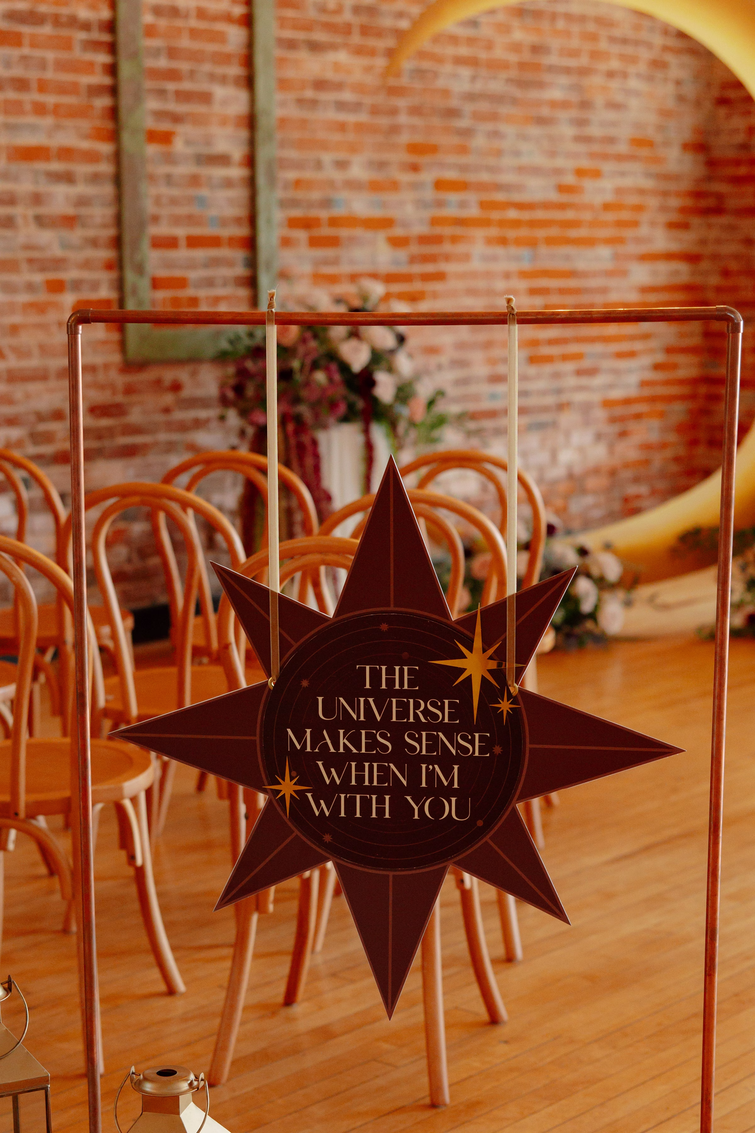a star-shaped welcome sign by LK Bridal Studio that says "The universe makes sense when I'm with you"