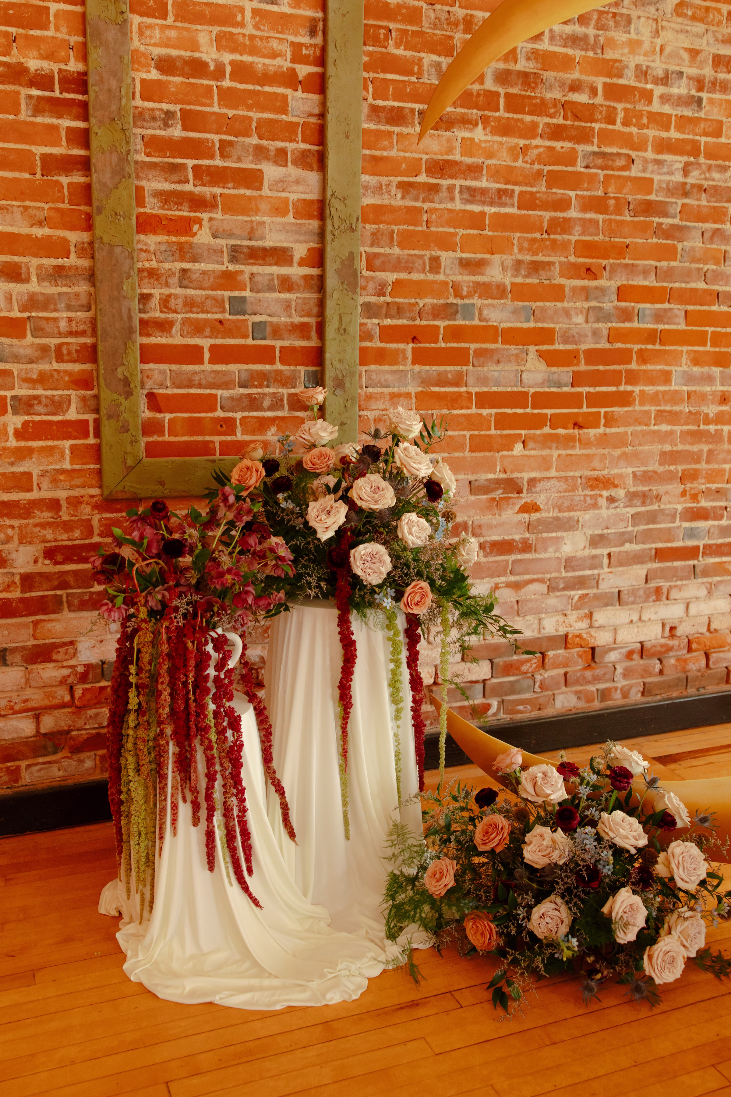 a detail photo of the floral pedestals on either side of the crescent moon ceremony backdrop