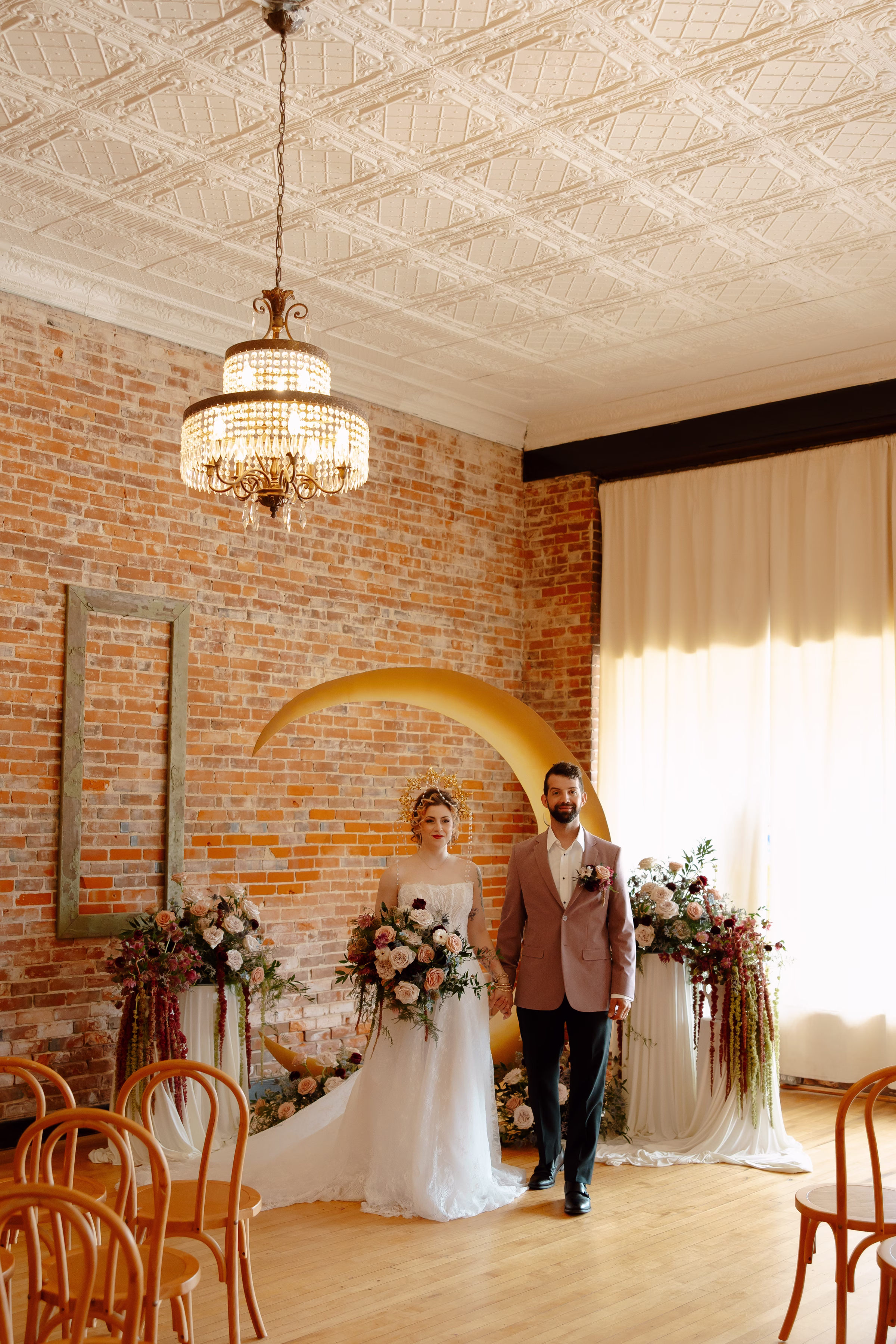 the couple holds hands, preparing to walk back down the aisle at the celestial ceremony