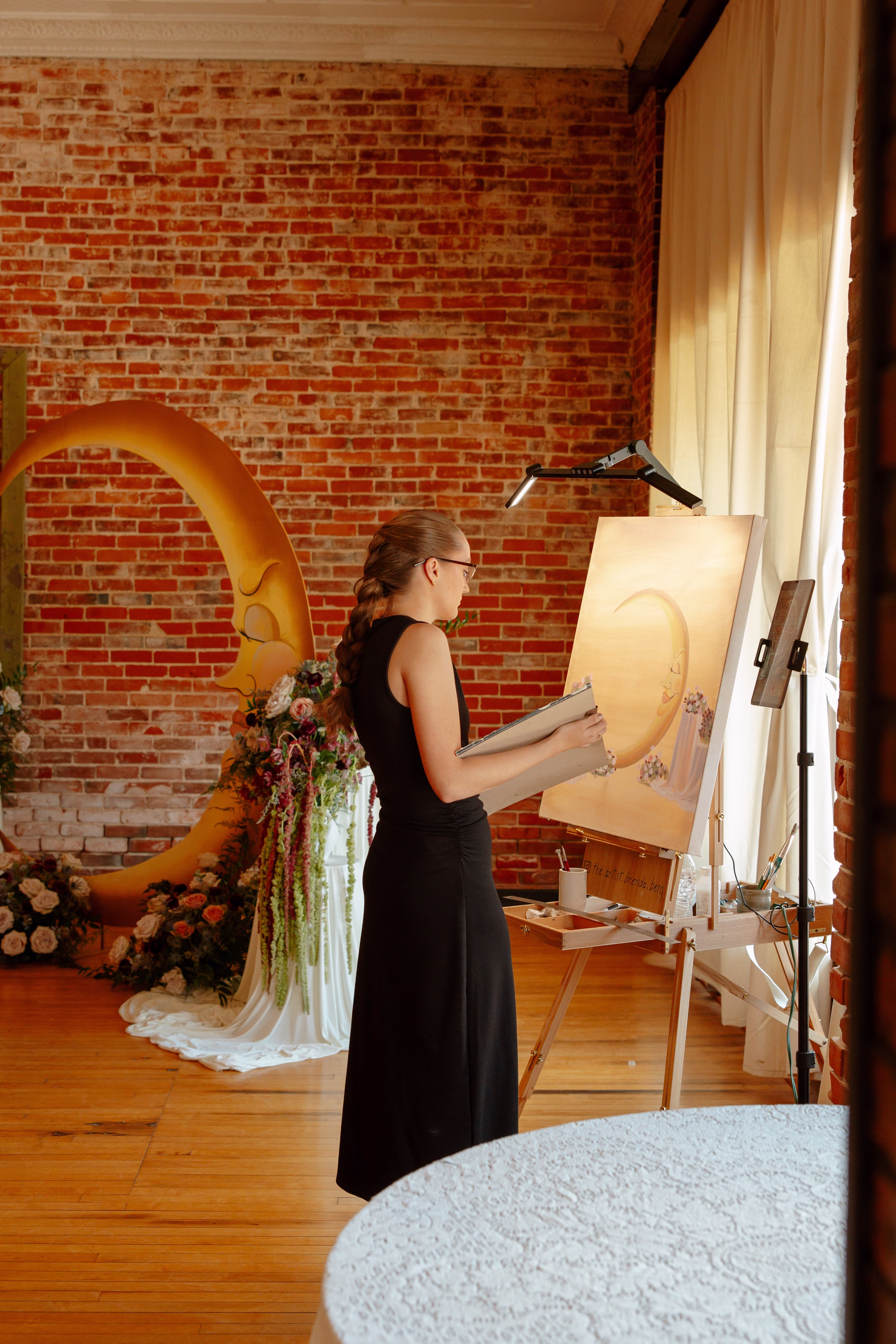 Live wedding painter, The Artist Brenda Berg, shows off her oil and acrylic skills at the celestial wedding ceremony at B's Place Event Venue in West Salem, Wisconsin
