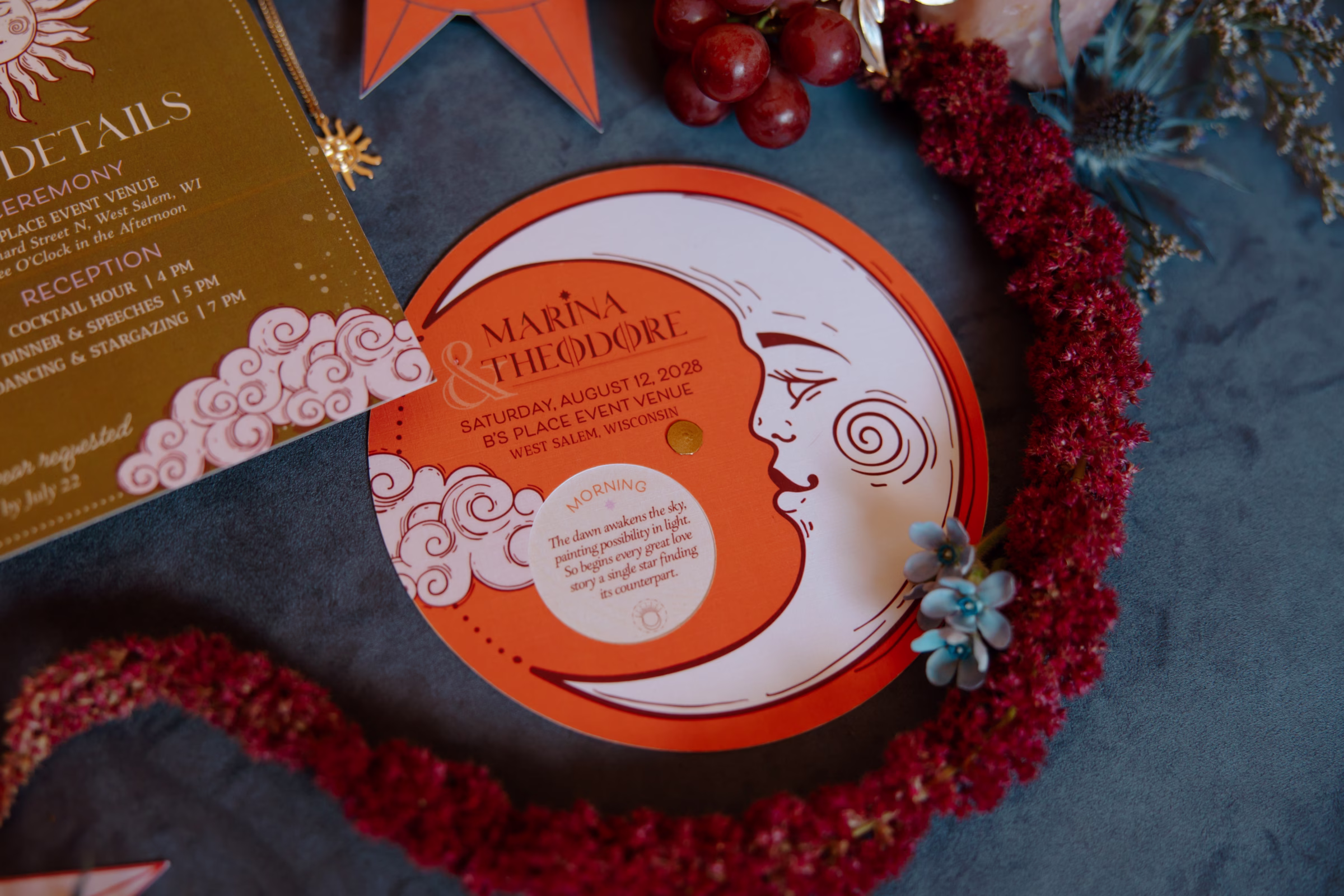 detail shot of a round, interactive volvelle stationery piece by LK Bridal Studio. The piece features a half moon and clouds, with a circle cutout that details the wedding day schedule from morning to reception