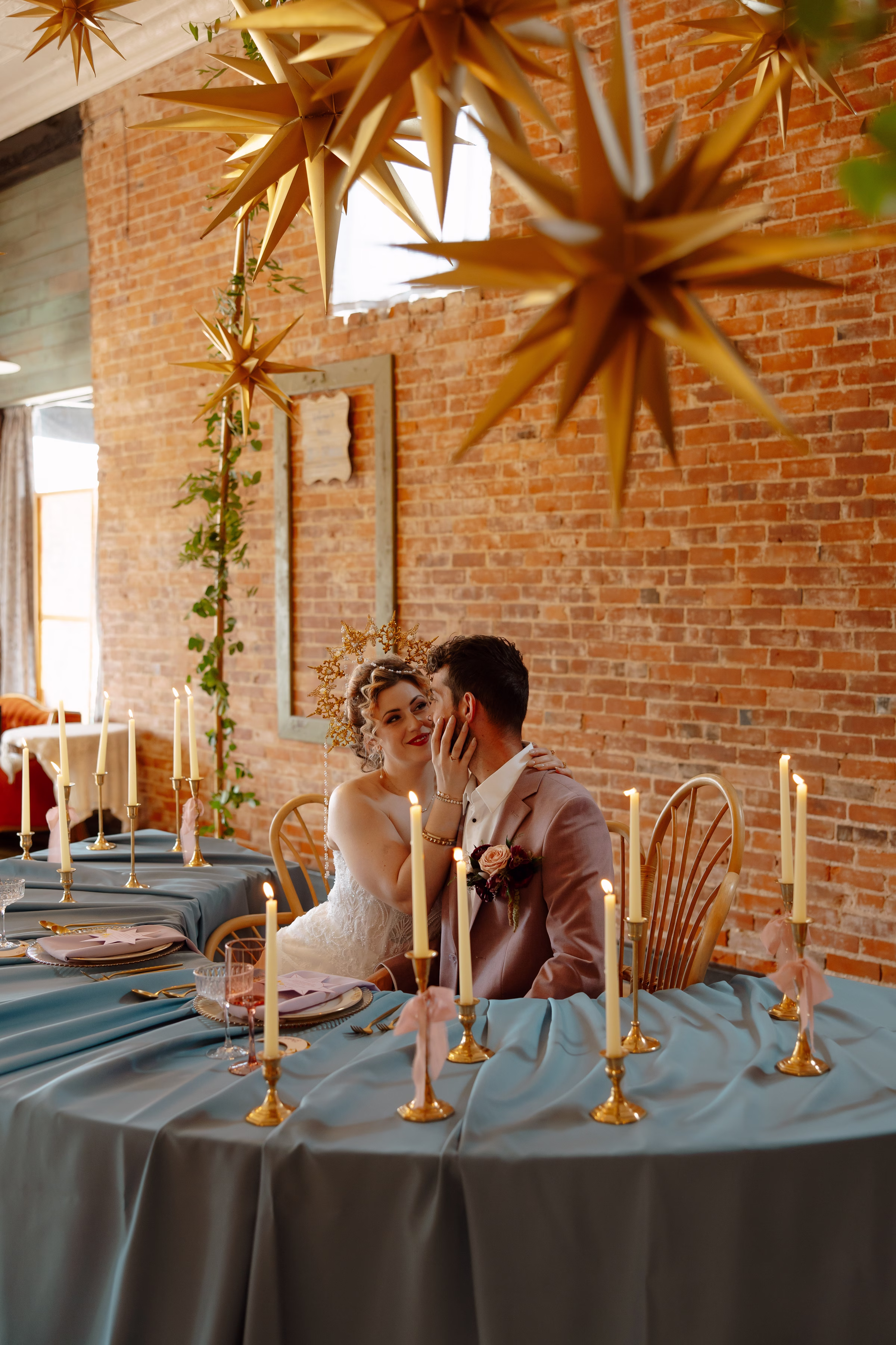 the bride and groom embrace at the sweetheart table at B's Place in West Salem, Wisconsin
