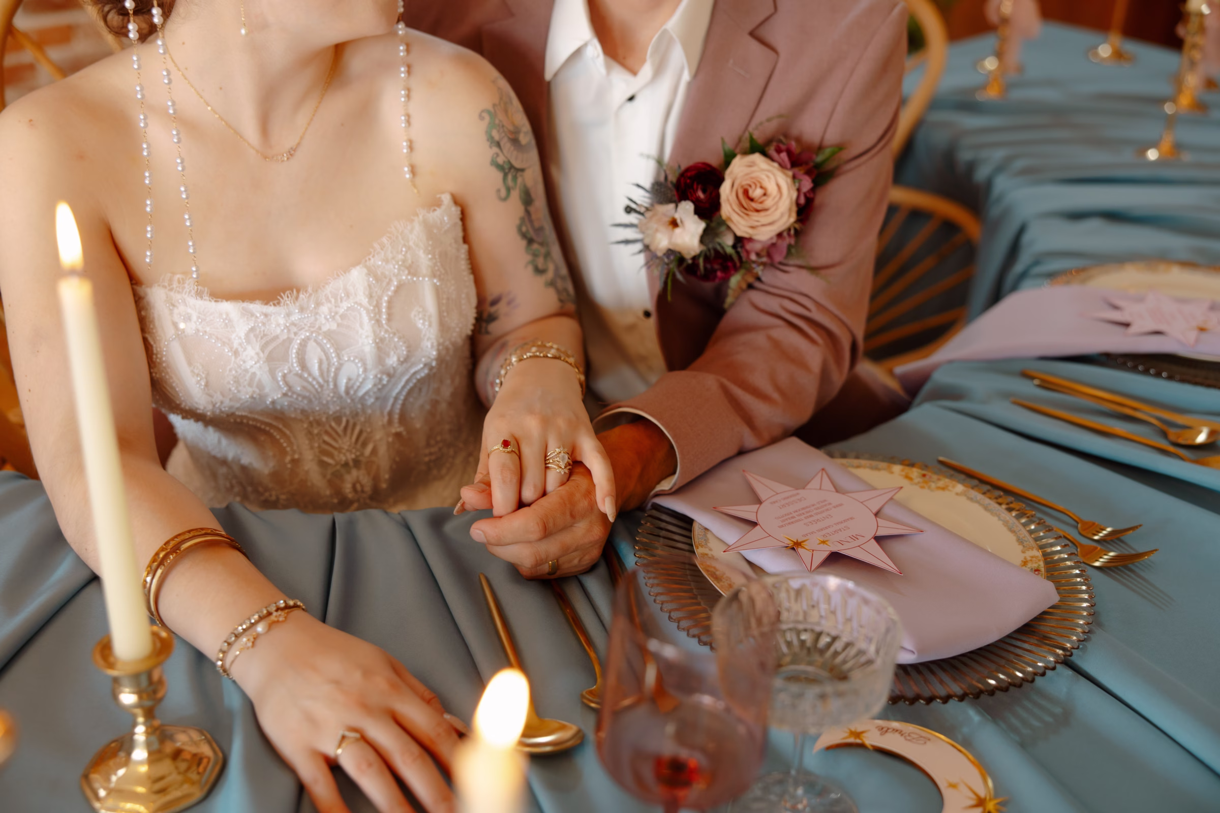 a close-up of the plating, cutlery, glassware, and linens at the sweetheart table