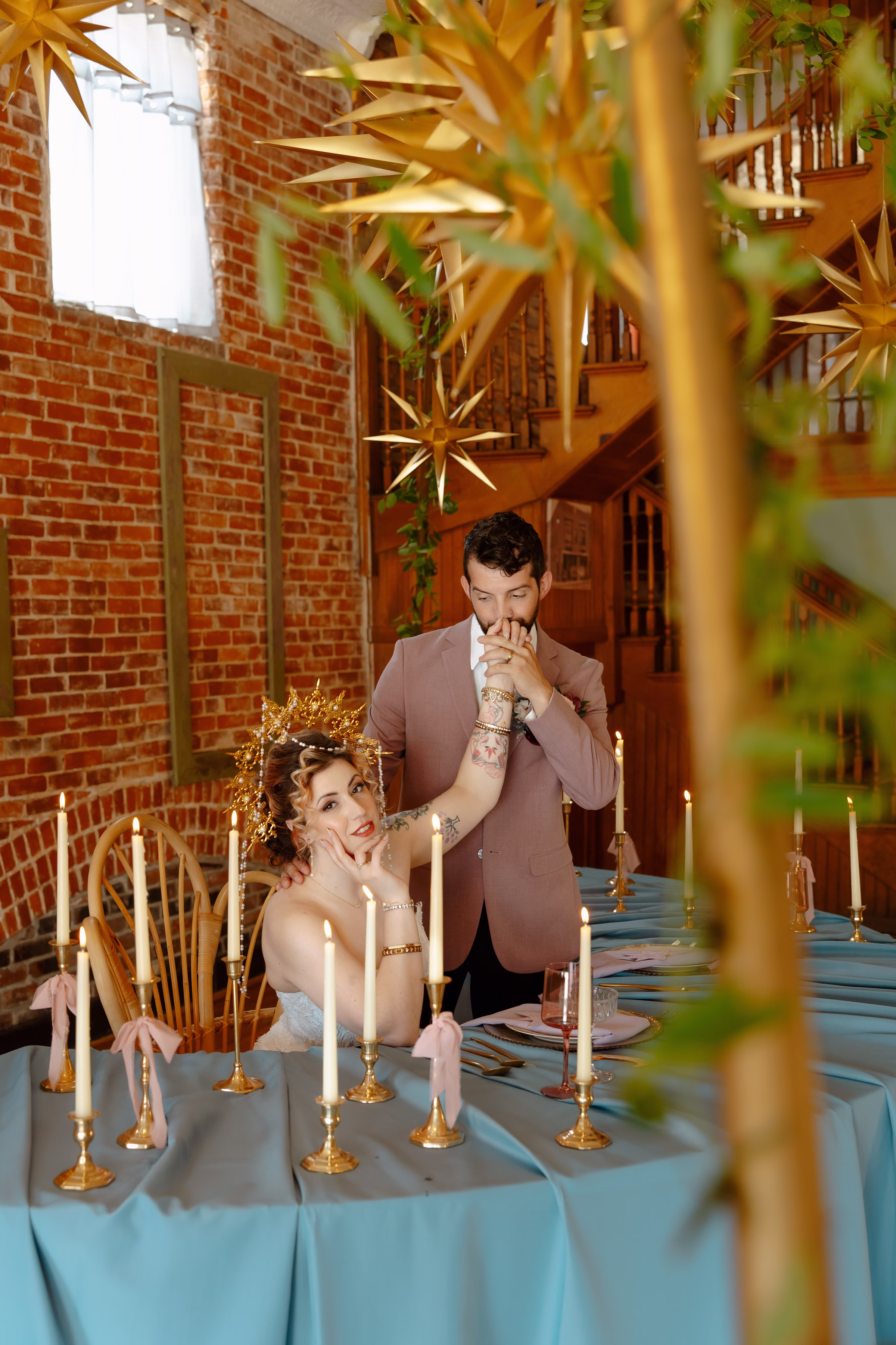 the couple poses at the sweetheart table