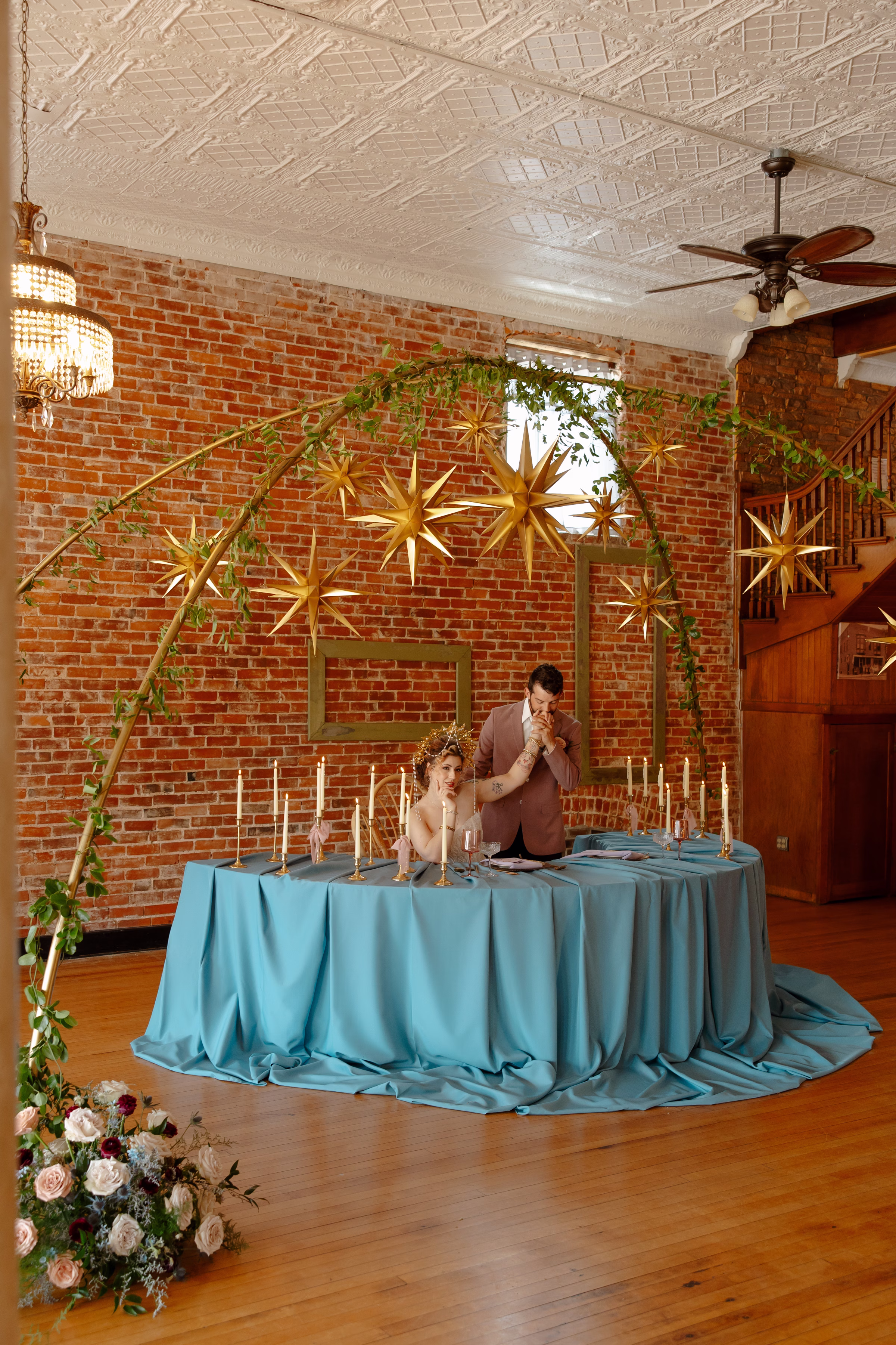a vertical photo depicting the couple at the sweetheart table