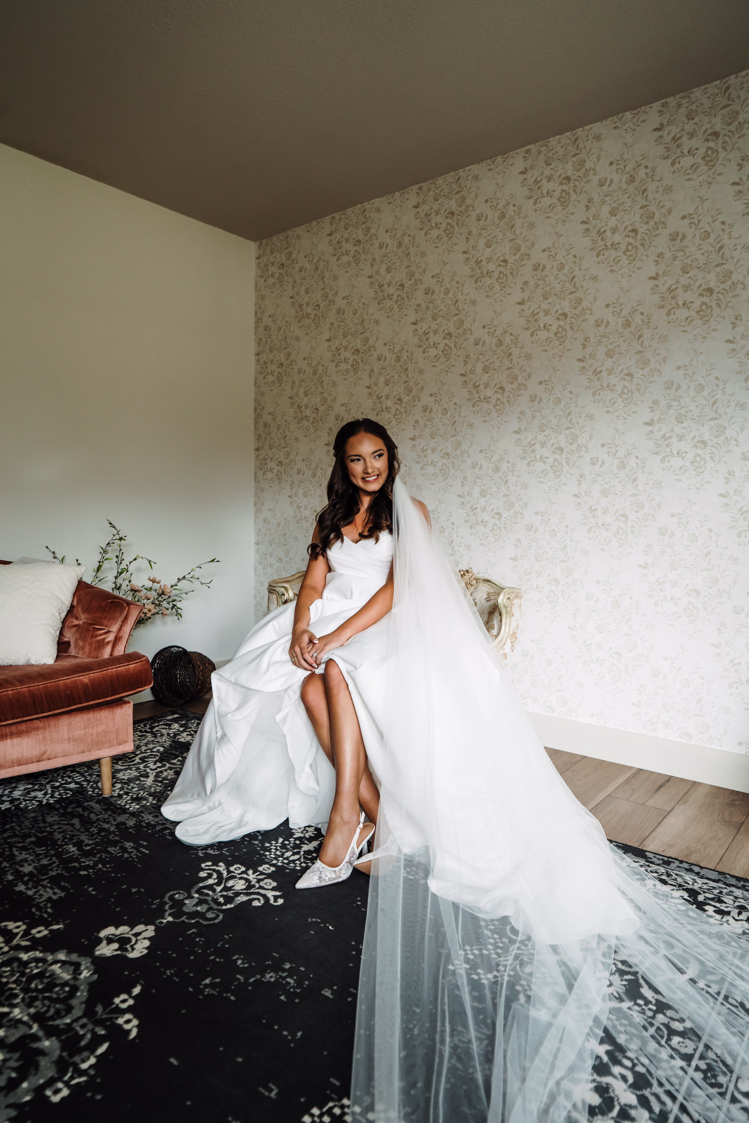 scenic fall wedding winnebago springs minnesota bridal preparation 3637 - An Elegant Fall Wedding at Winnebago Springs | Emma & Tyler a bride smiles as she takes getting-ready photos on her wedding day