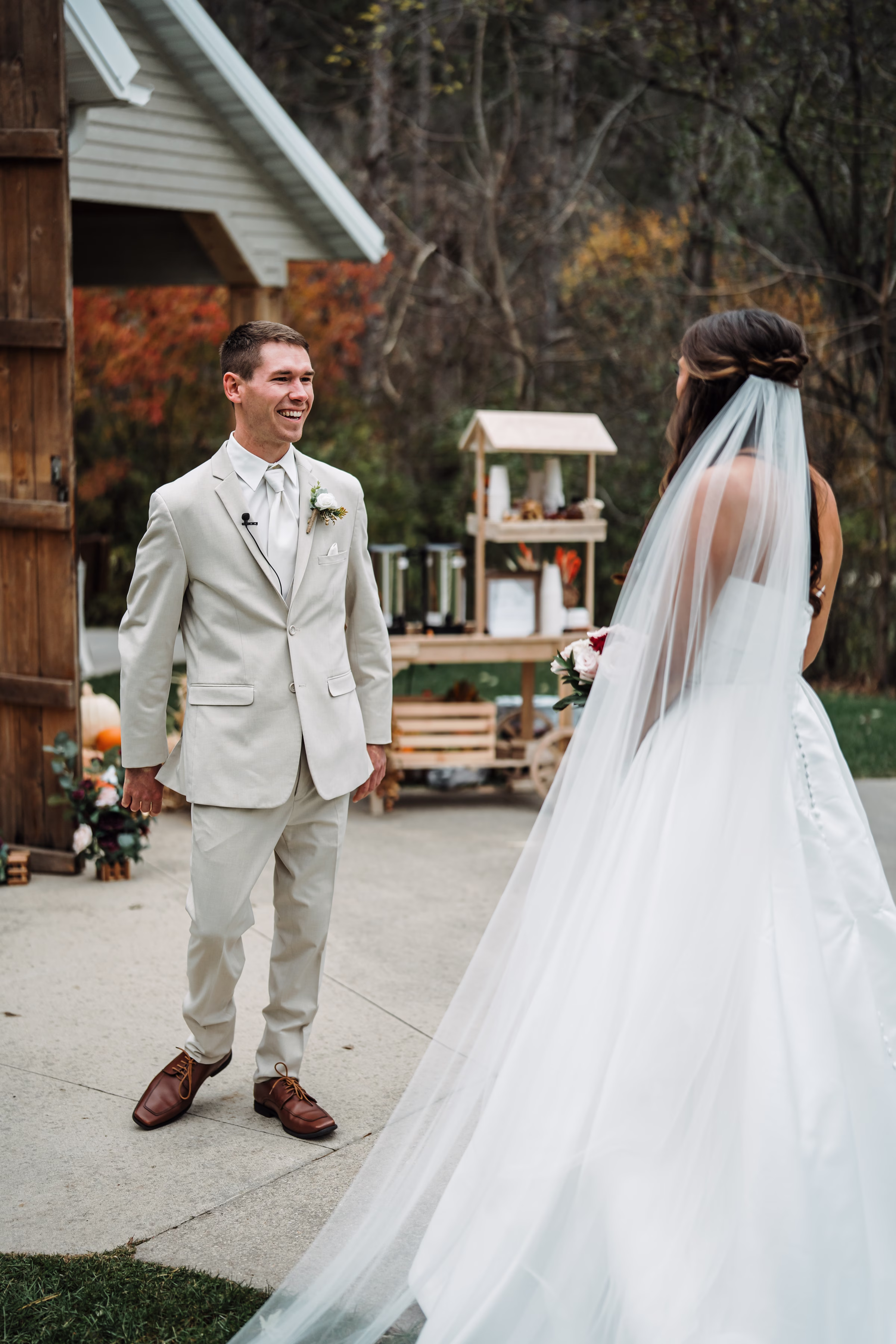 scenic fall wedding winnebago springs minnesota first look 0545 - An Elegant Fall Wedding at Winnebago Springs | Emma & Tyler a groom beams at his bride as he turns around during a first look