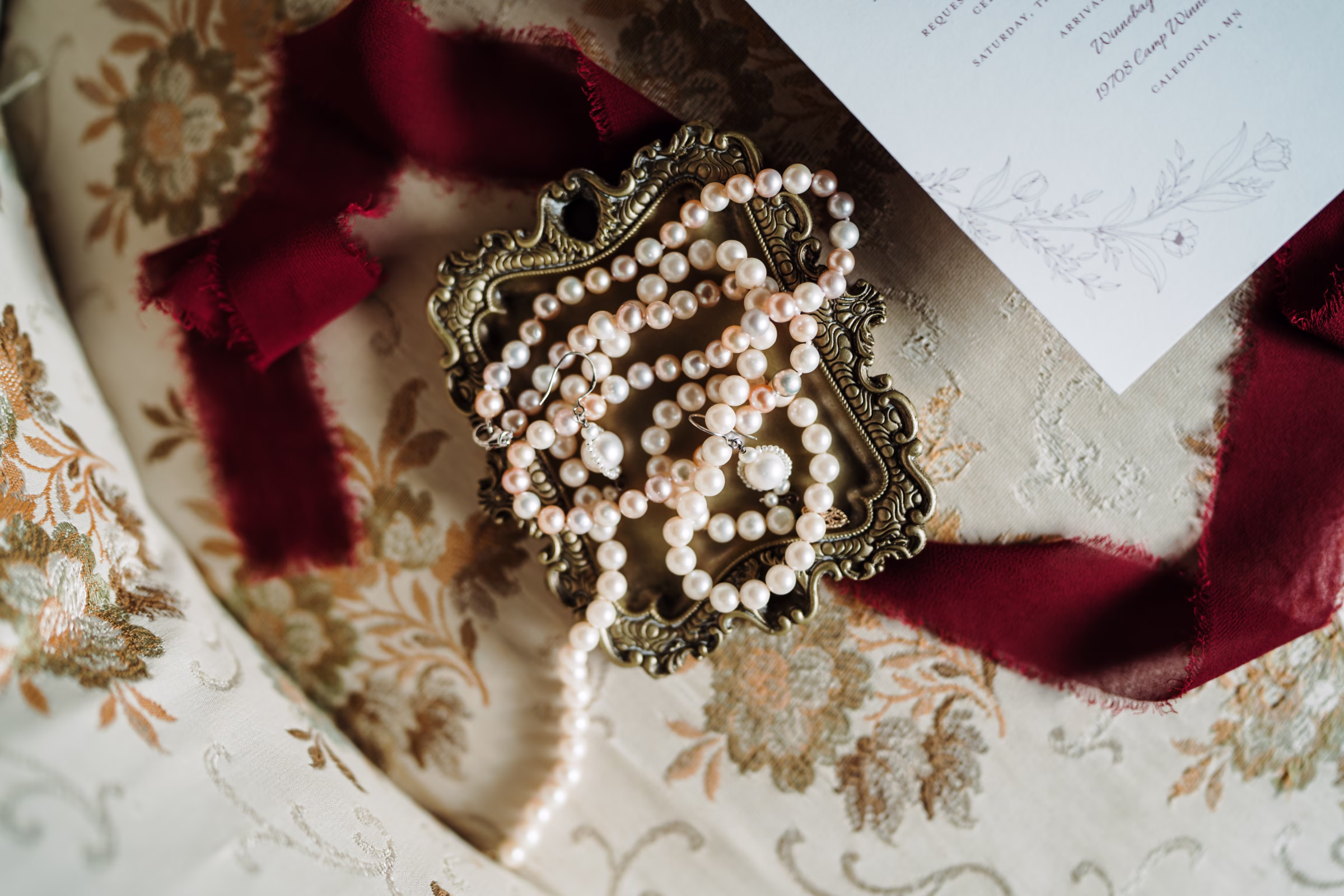scenic fall wedding winnebago springs minnesota pearl necklace 3418 - An Elegant Fall Wedding at Winnebago Springs | Emma & Tyler a detail photo showing a pearl necklace and pearl earrings
